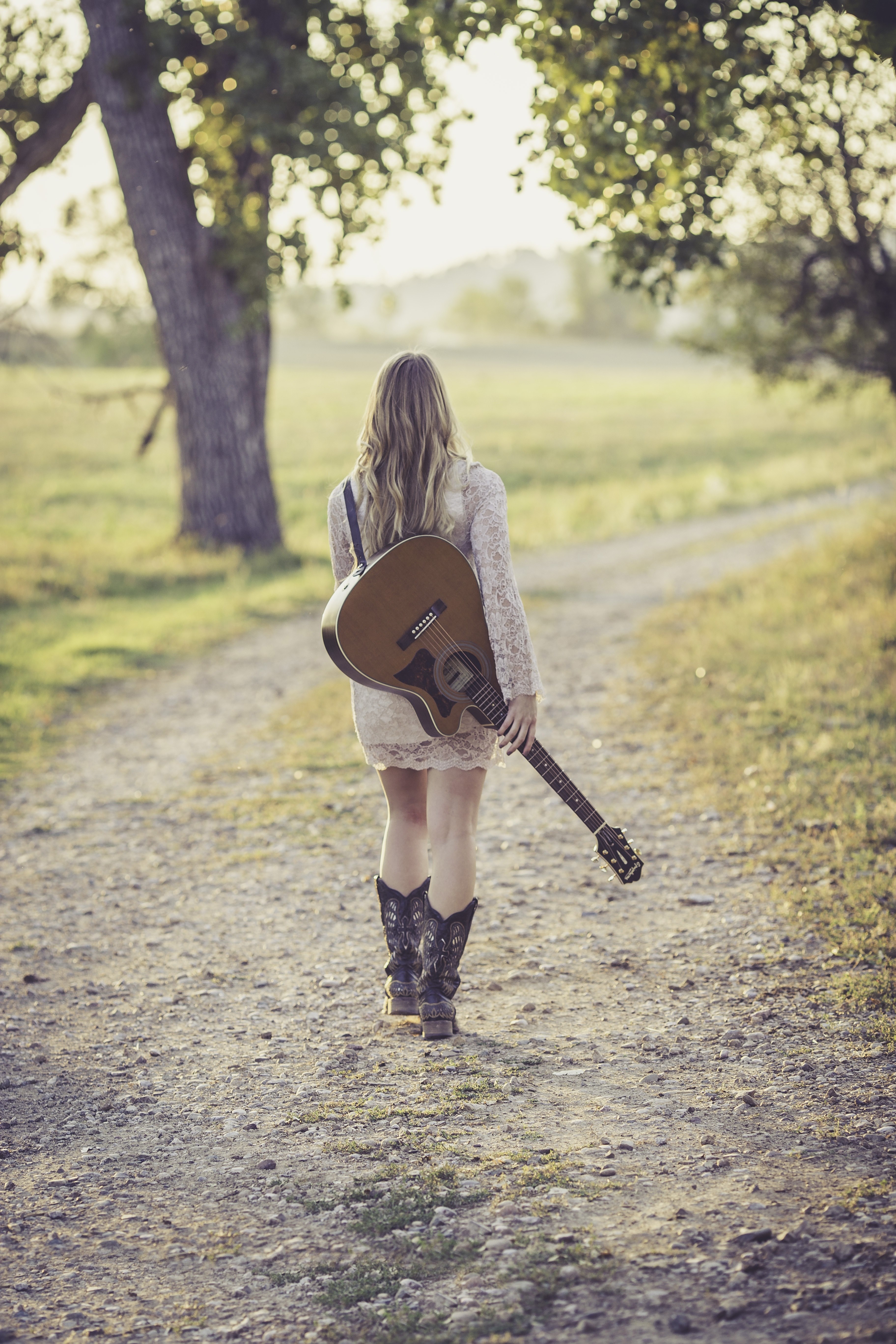Wallpaper / guitar country road young female musician outdoor 4k wallpaper