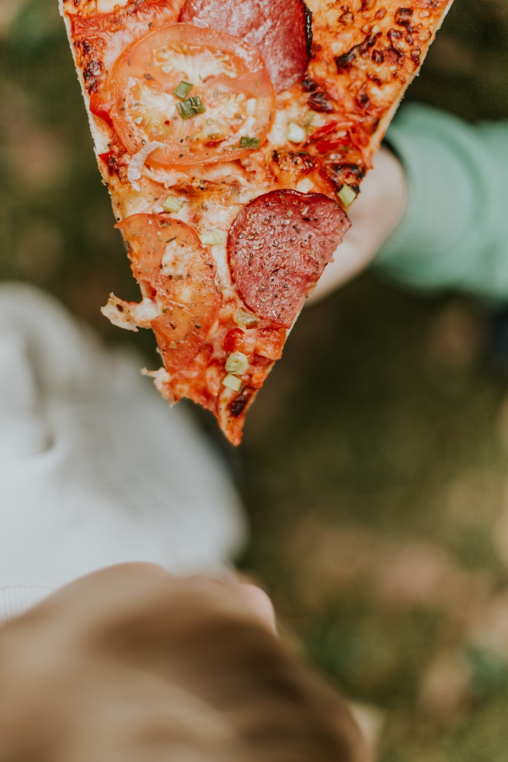 tomato and pepperoni pizza with cheese in selective focus photography photo